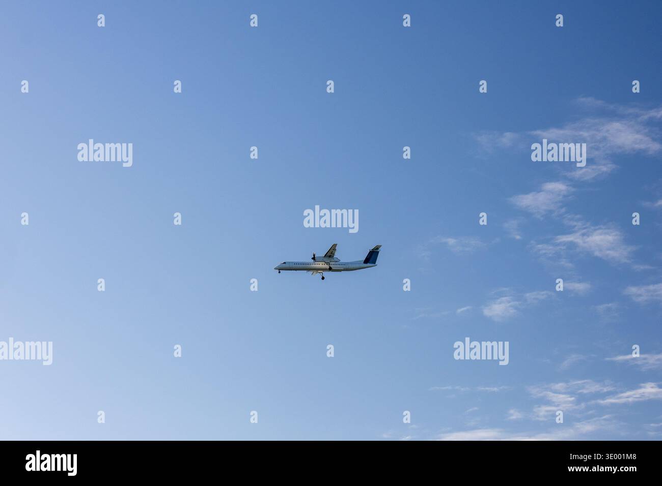 Turboprop airplane flying in a clear blue sky over Iona Beach Regional ...