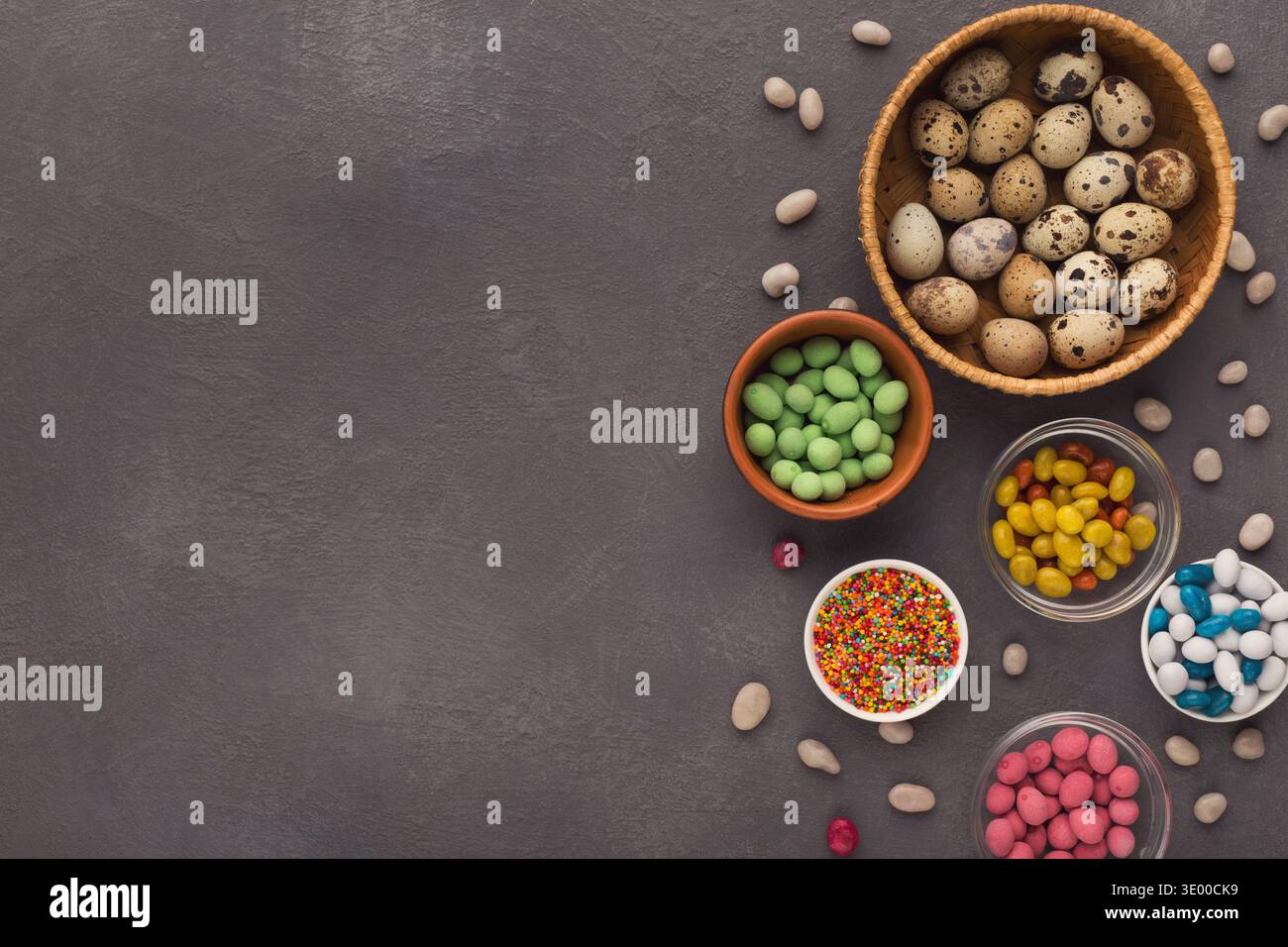 Easter eggs and sprinkles on gray slate background Stock Photo