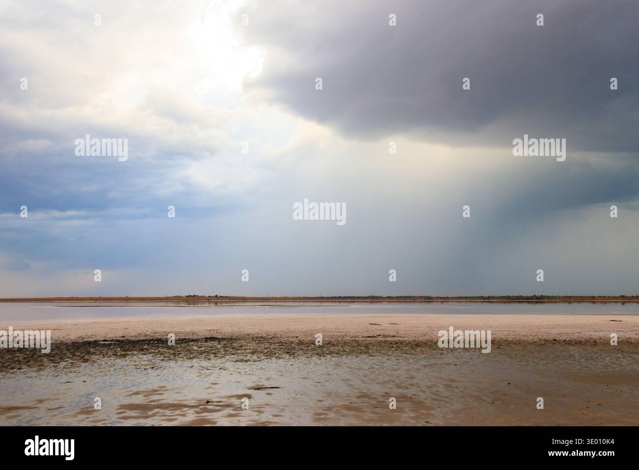 Dark storm clouds over a salt lake before a rain Stock Photo