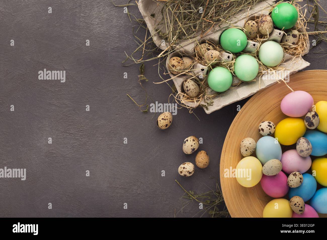 Easter background. Colored eggs on gray stone surface Stock Photo