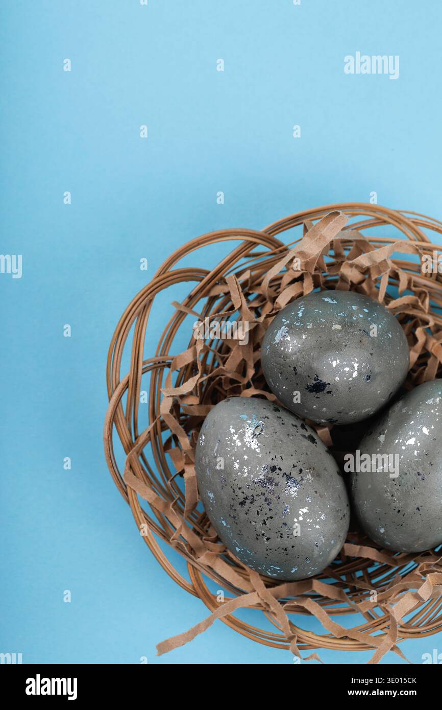 Close up Easter eggs with silver texture in nest and ribbon Stock Photo