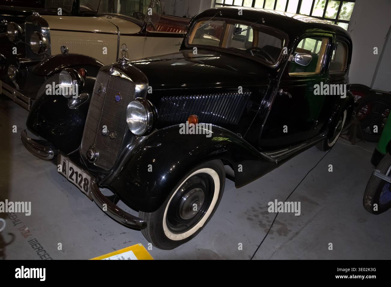 Classic black Mercedes-Benz 170 V sedan from the late 1930s, featuring whitewall tires and iconic chrome grille, on display at the Belgrade Automobile Stock Photo