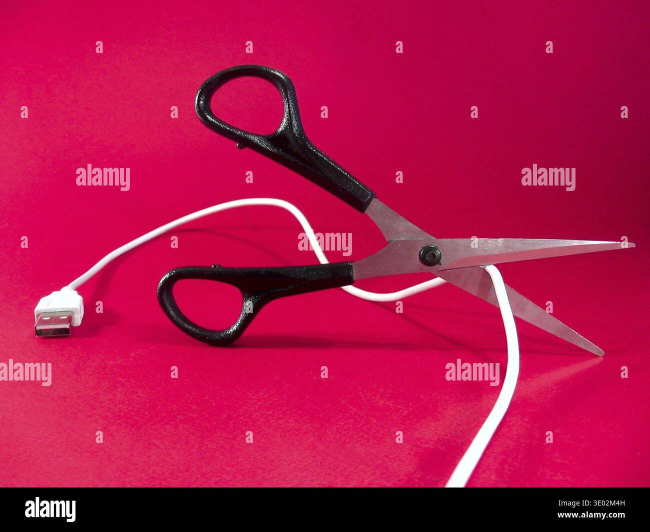 Cutting wire with scissors - tech, internet, information and communication styled concept, elegant visuals Stock Photo