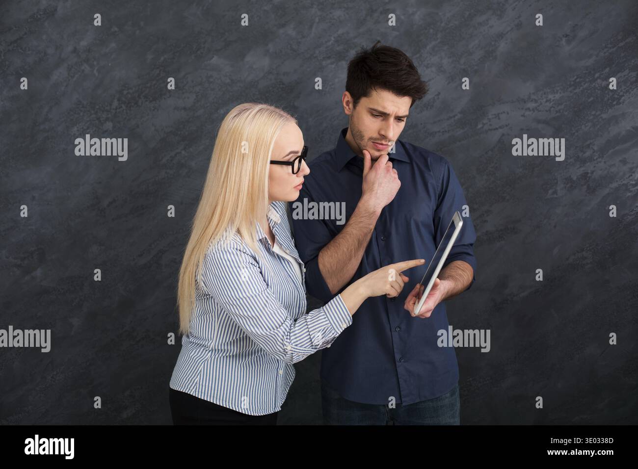 Serious business partners using digital tablet at studio Stock Photo