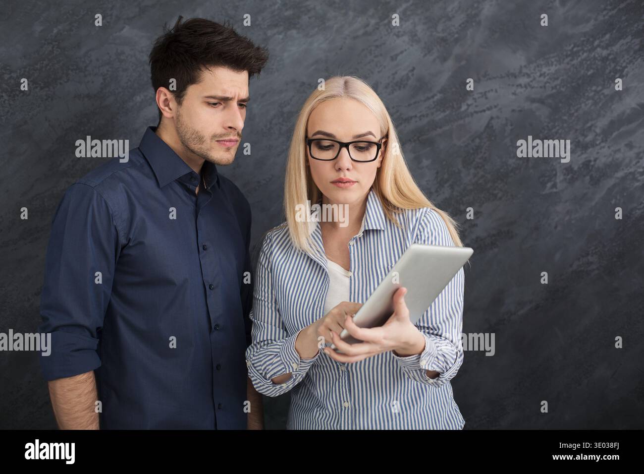 Serious business partners using digital tablet at studio Stock Photo