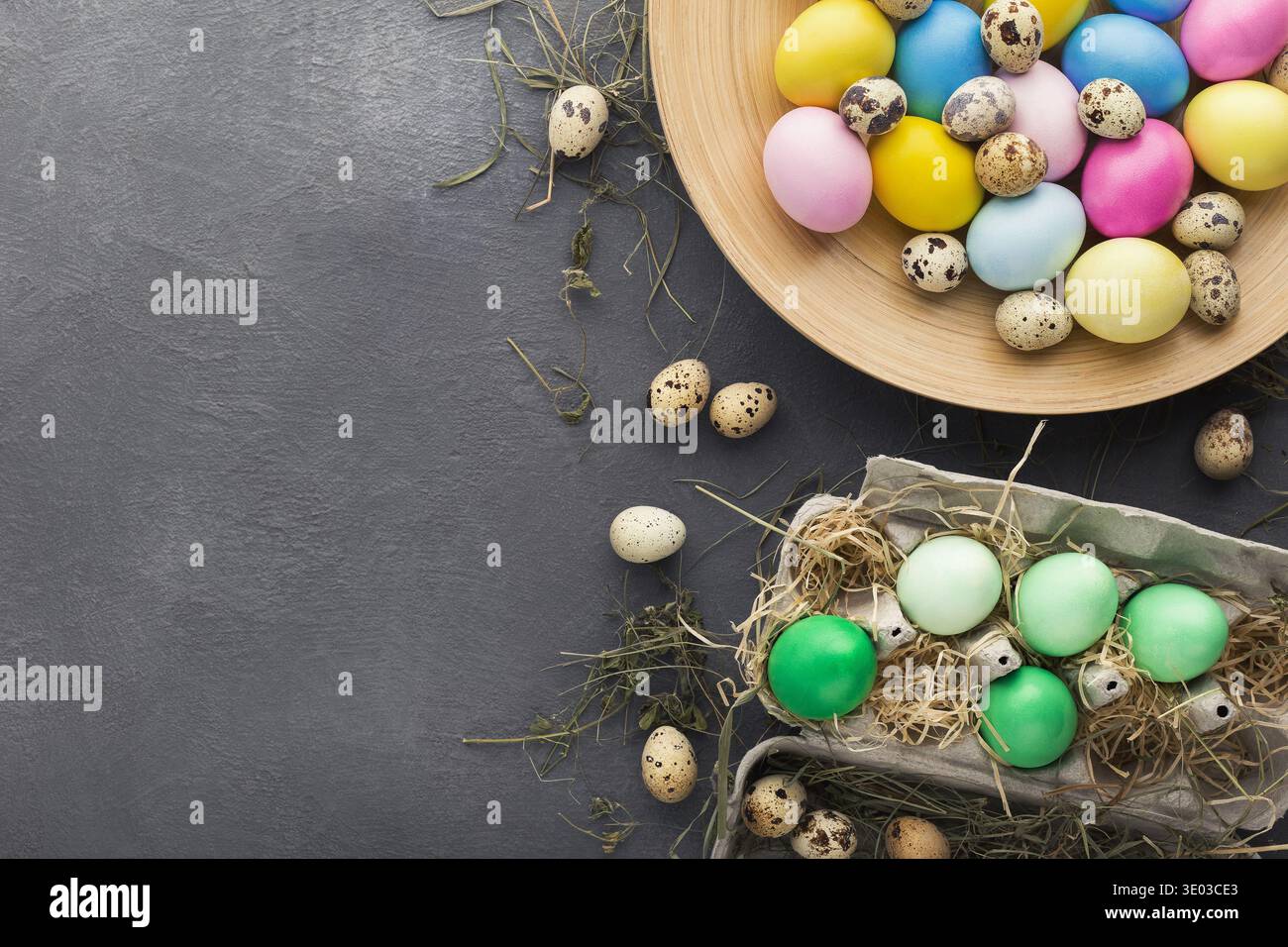 Colored Easter and quail eggs set on black table Stock Photo