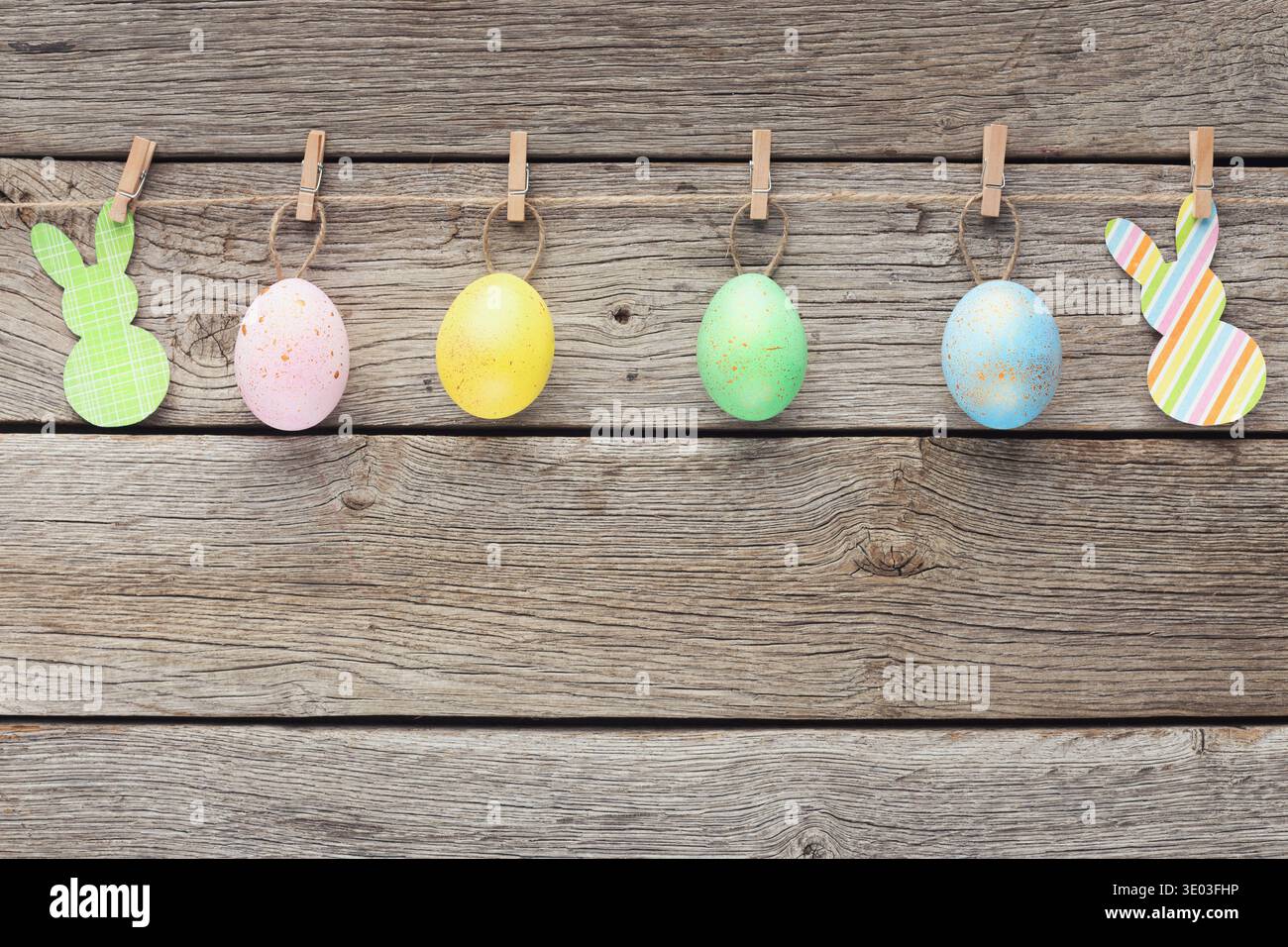 Colourful eggs and raper rabbits on rope Stock Photo
