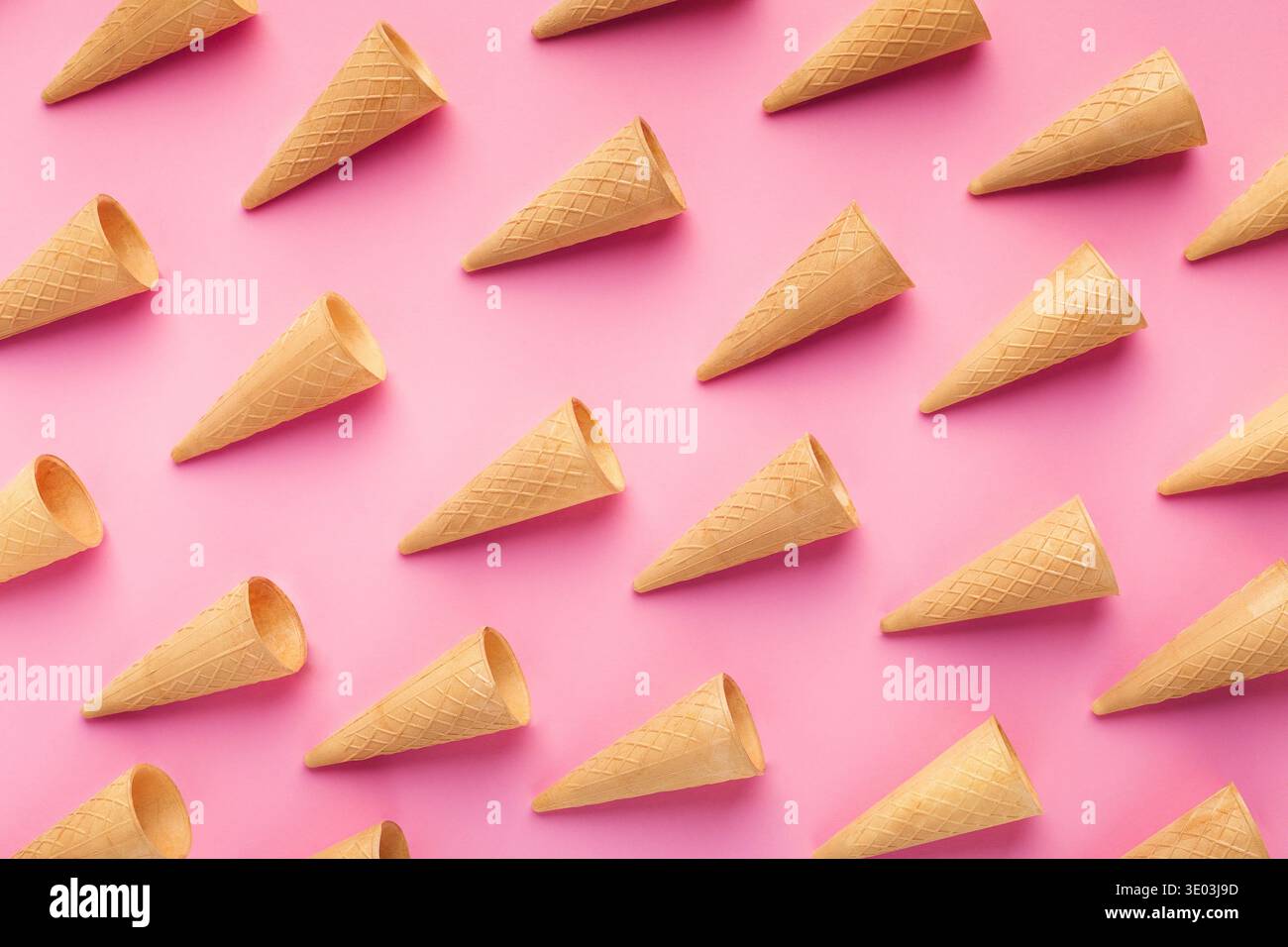 Empty wafer ice cream cones on pink background Stock Photo