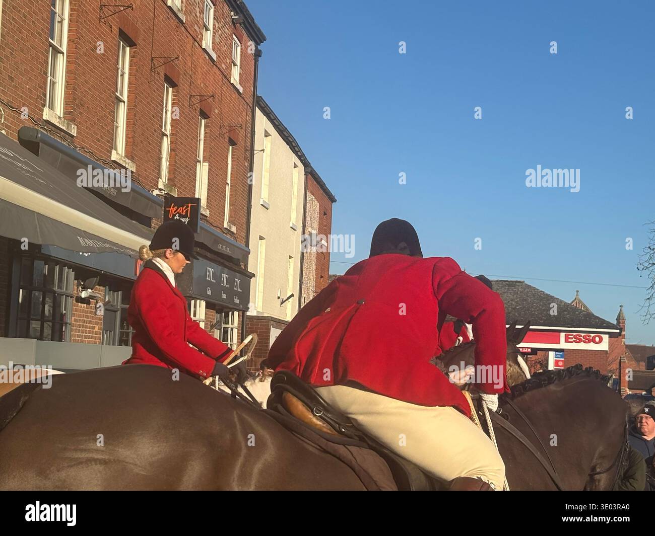 Joint Masters Of The Hunt wit female and male riders dressed in tradtional red hunting jackets and white breeches gather on horse back in front. DN10 - Smartphone Captured Stock Image