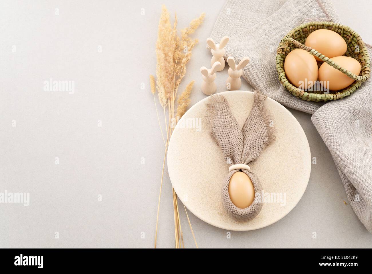 Zero waste Easter. Rustic easter table setting with bunny ear napkin Stock Photo