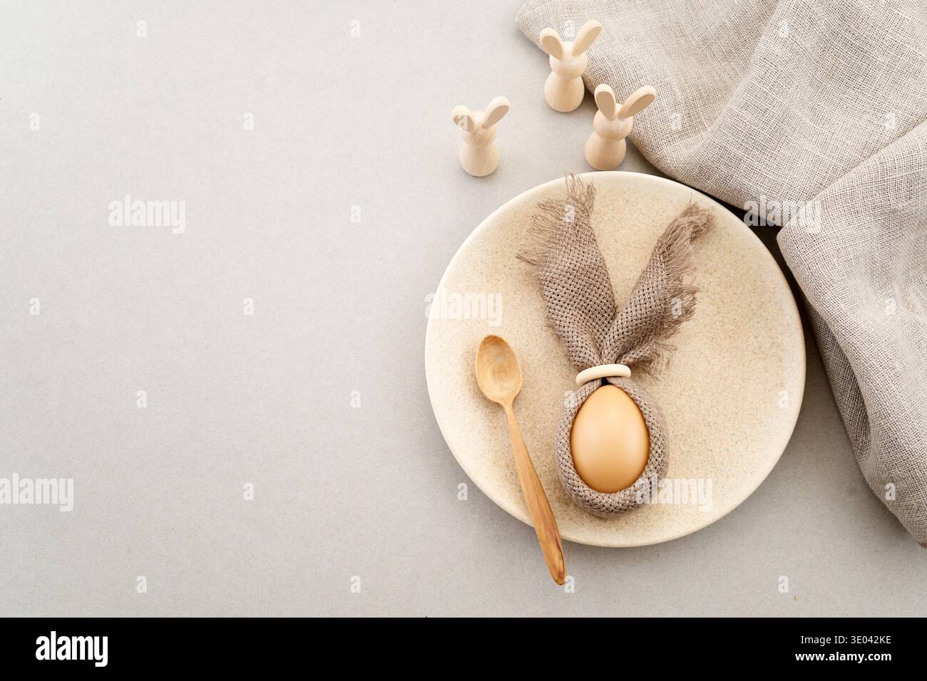 Zero waste Easter. Easter table setting with egg bunny and wooden rabbits Stock Photo