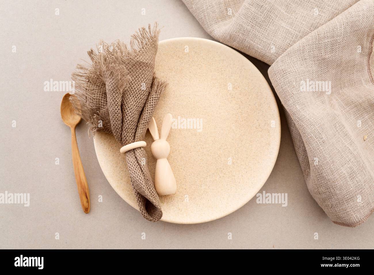 Zero waste Easter. Easter table setting with wooden bunny and linen napkin Stock Photo