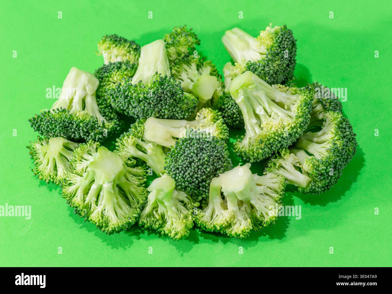 Green broccoli cabbage isolated on a green background. Stock Photo