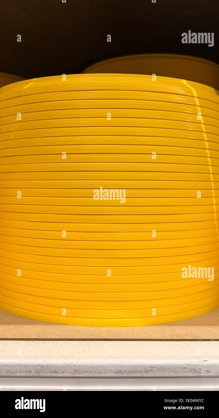 Yellow ribbed plastic surface. Abstract industrial background with horizontal lines. Stock Photo
