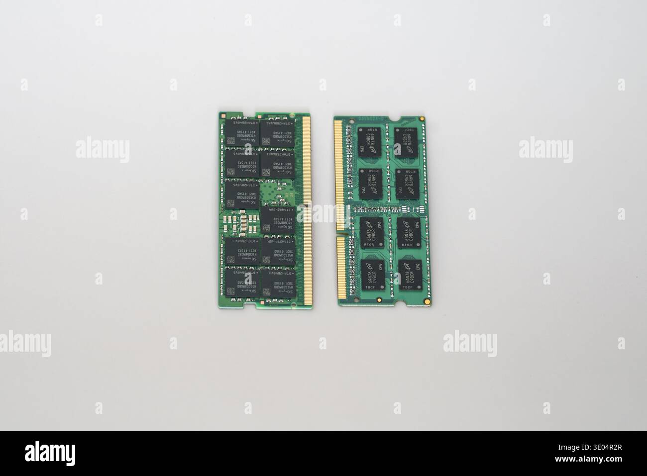 Two computer memory modules, one DDR5 ECC and one DDR3, displayed against a clean white background for comparison. Stock Photo