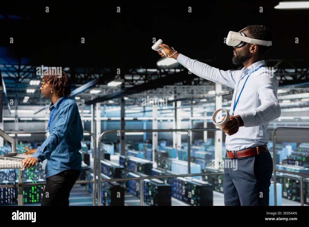 African american IT programmer uses virtual reality tech on industrial platform, collaborating on automation tasks. Server hub engineer visualizing large language model infrastructure with VR. Stock Photo