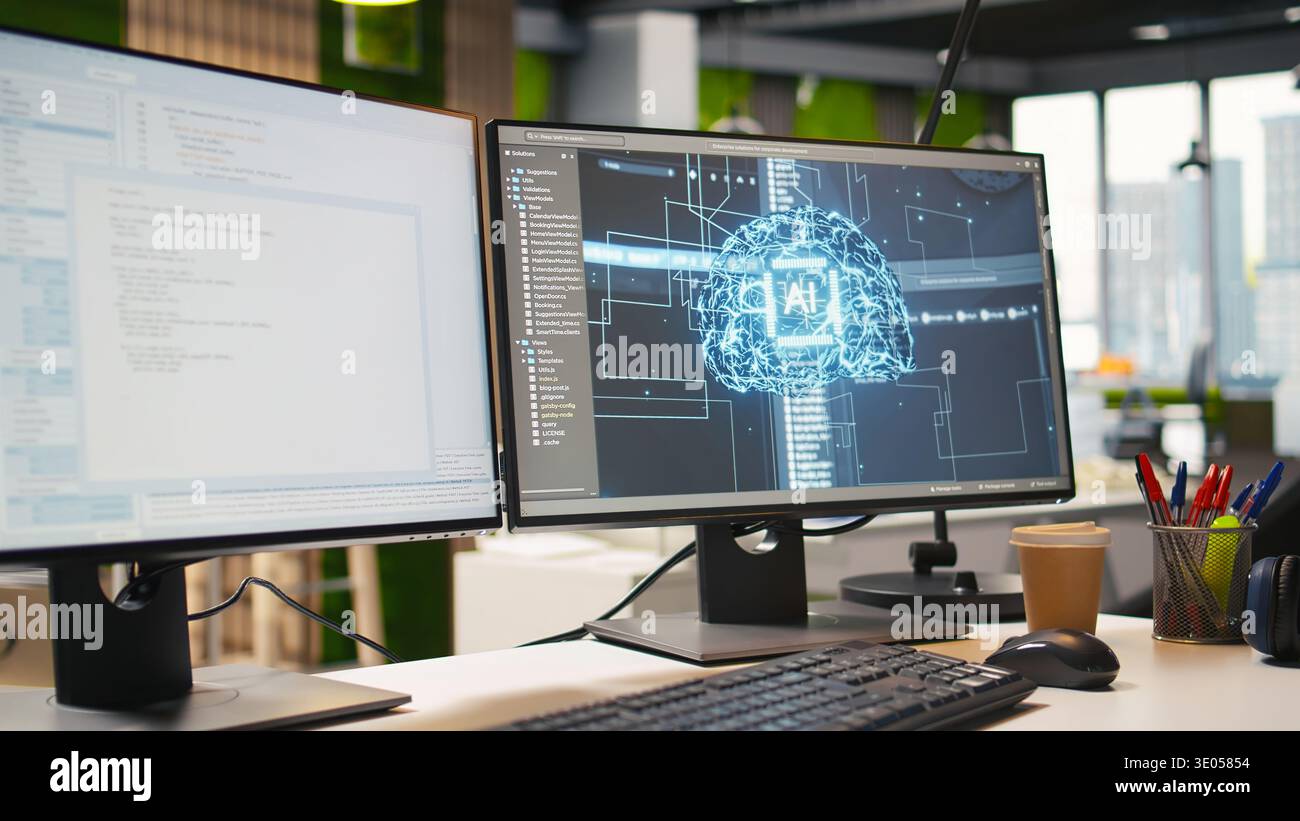 Advanced AI algorithms running on computer monitors in empty startup workspace deploying machine learning models. Artificial intelligence coding platform on PC screens in modern office Stock Photo