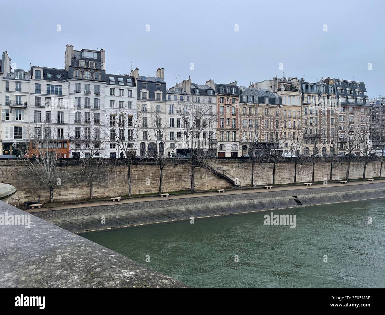 Paris, France. A row of Haussmann-style historic buildings along the Quai de Bourbon on the Île Saint-Louis. - Smartphone Captured Stock Image