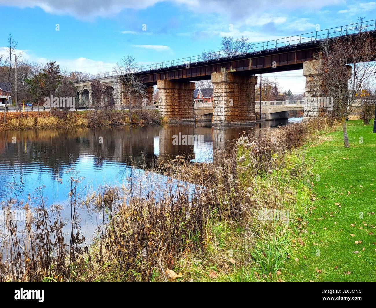 An Old Train Bridge Crossing Over A River In A Small Town Village - Smartphone Captured Stock Image