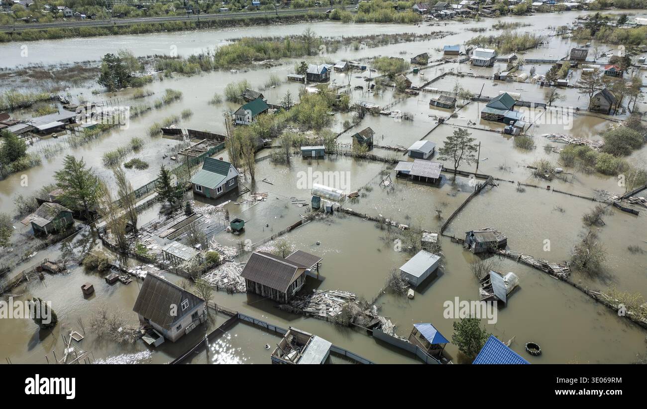 Spring flood disaster with fully submerged houses, flooded roads and ...