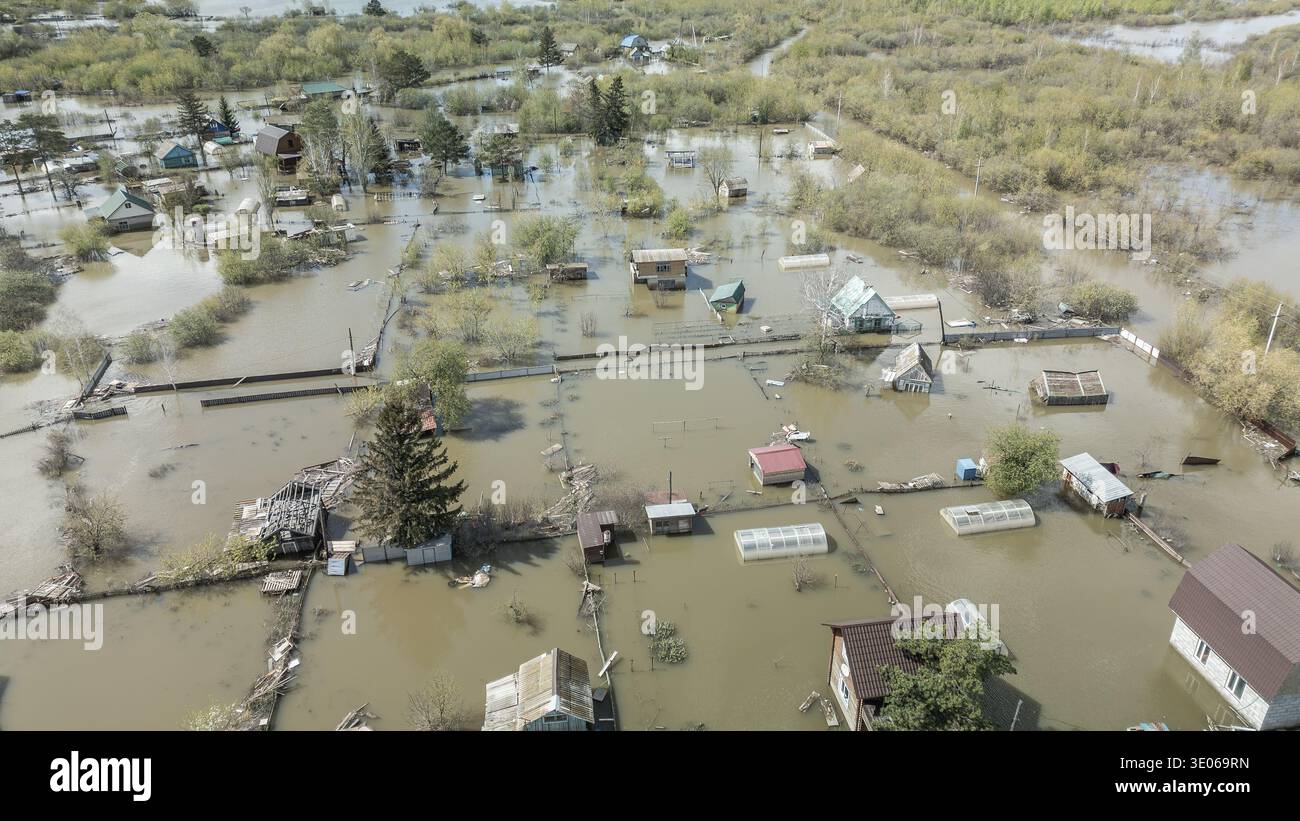 Spring flood disaster with fully submerged houses, flooded roads and ...