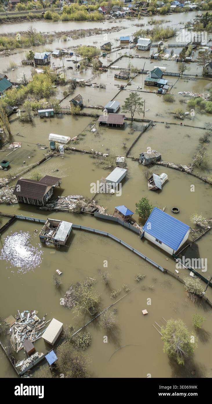 Spring flood disaster with fully submerged houses, flooded roads and ...