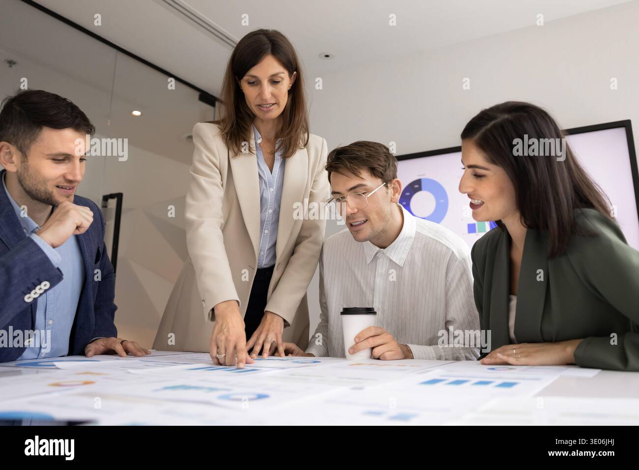 Team engaged in discussion, analyzing results and developing strategic ideas Stock Photo