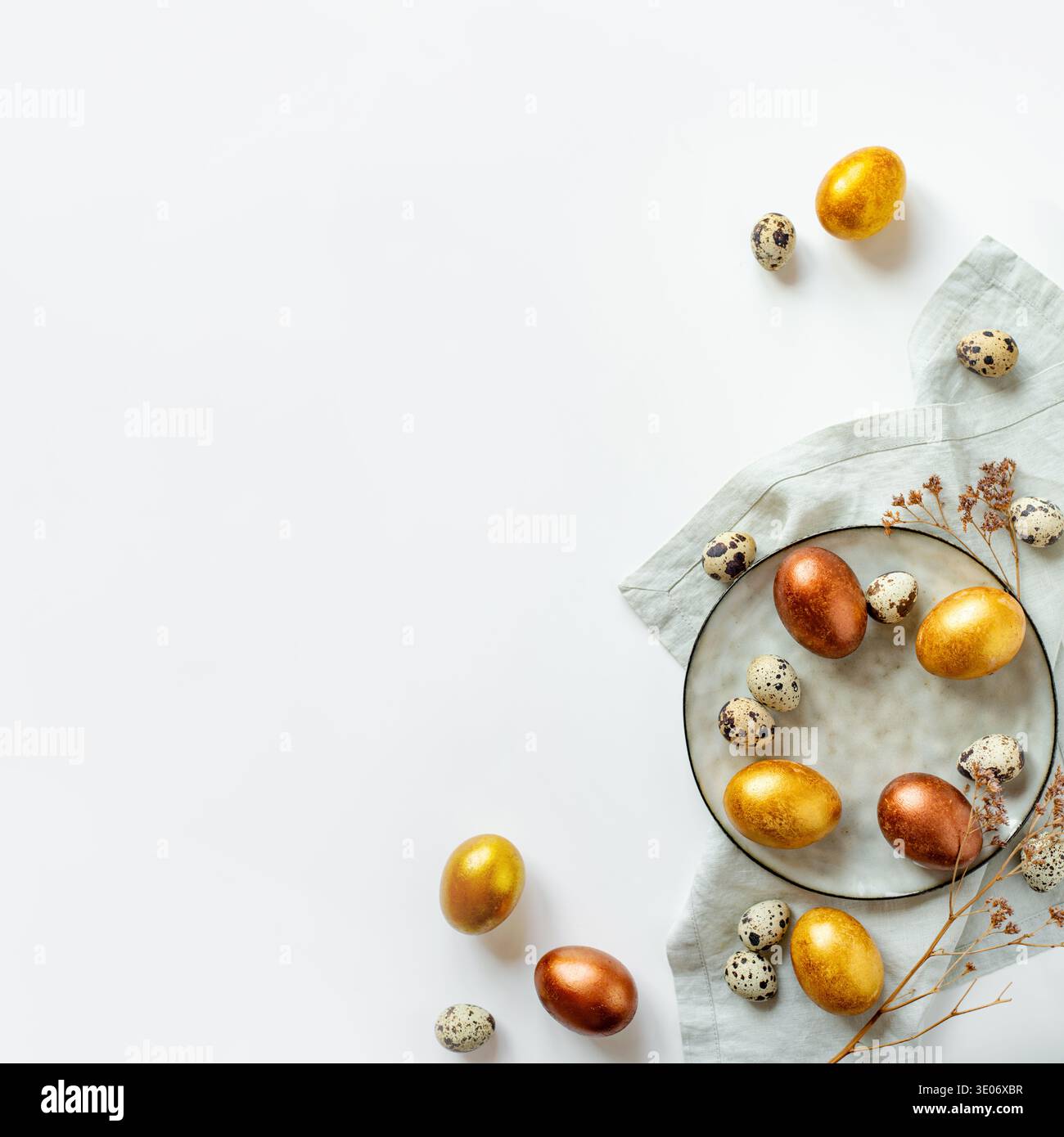 Golden and bronze Easter eggs in a grey plate Stock Photo