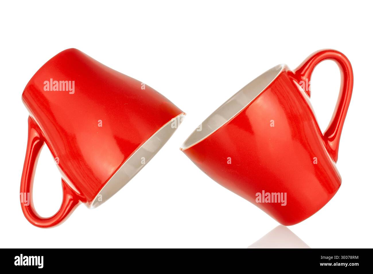 Two ceramic red coffee cups, close-up, isolated on white background. Stock Photo