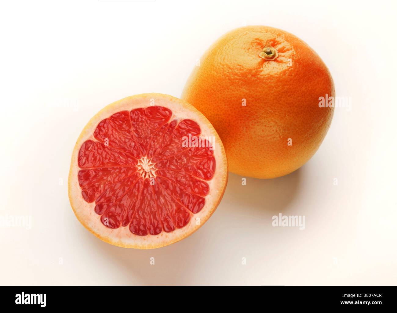 Whole and cut grapefruits isolated on white background Stock Photo