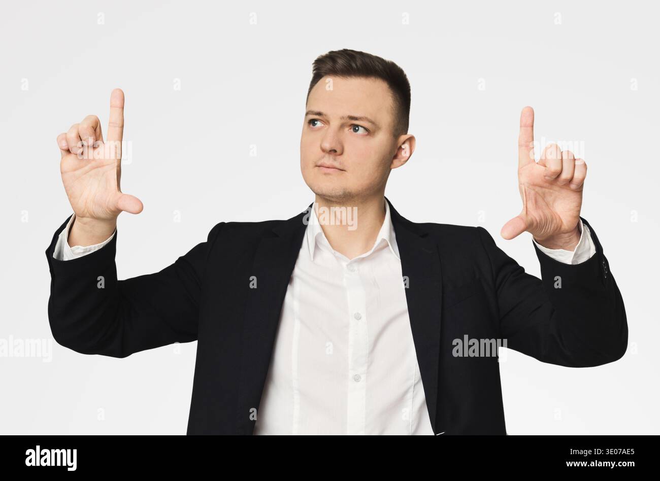 Young businessman using virtual screen for work Stock Photo