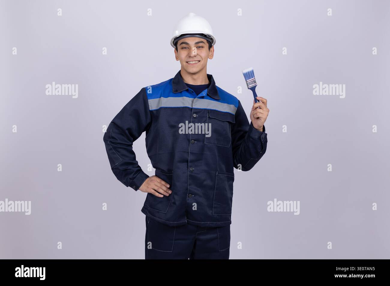 Construction worker holding a small tool Stock Photo