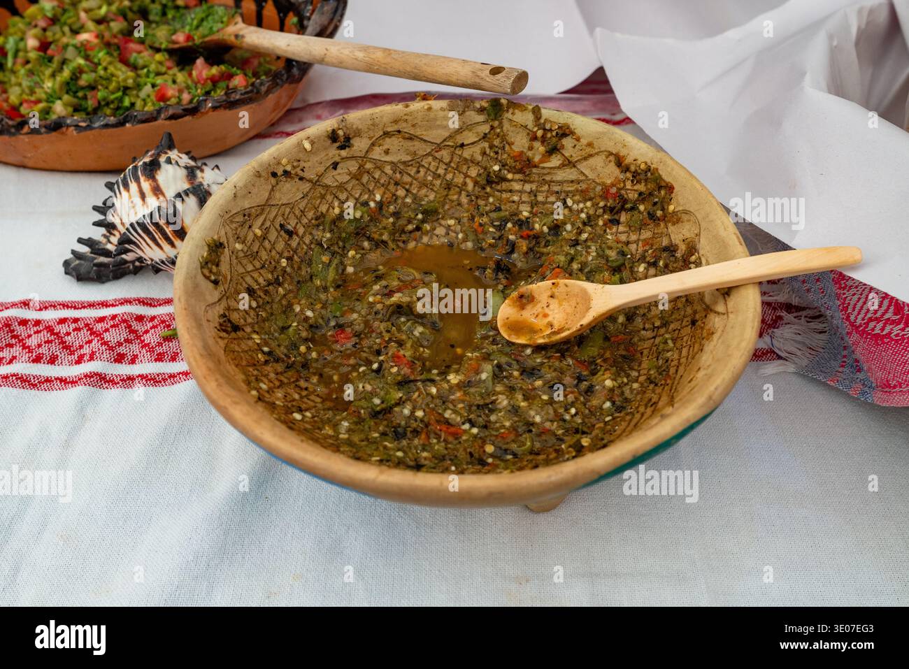 Traditional Rustic Bowl of Salsa Verde with Wooden Spoon. Close Up Still Life Stock Photo