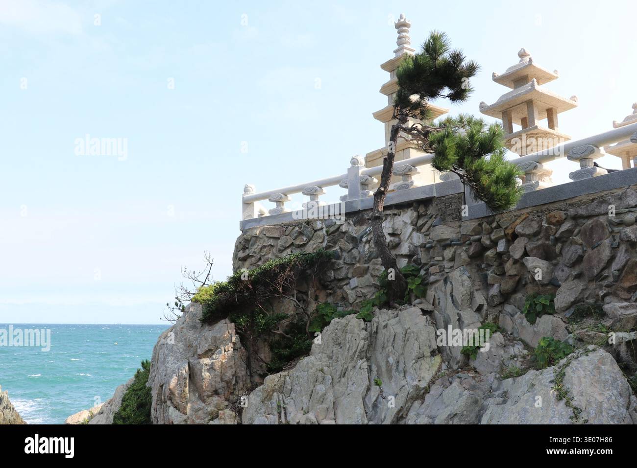Coastal temple structures standing on rocky cliffs overlooking the sea ...