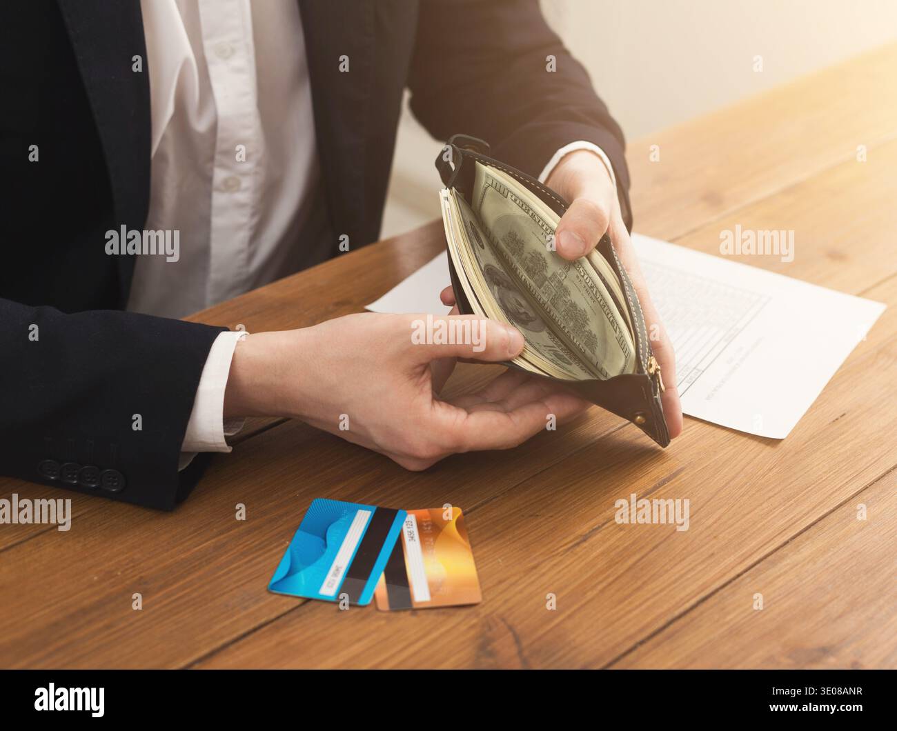 Man's hands holding open wallet with money Stock Photo