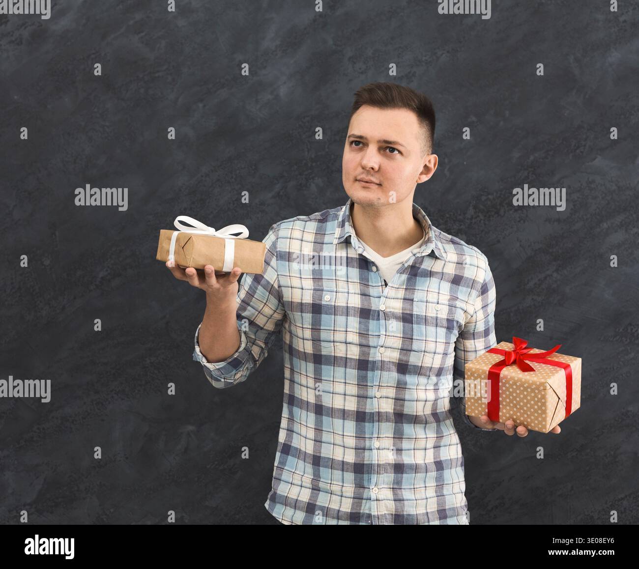 Curious man trying to guess present Stock Photo