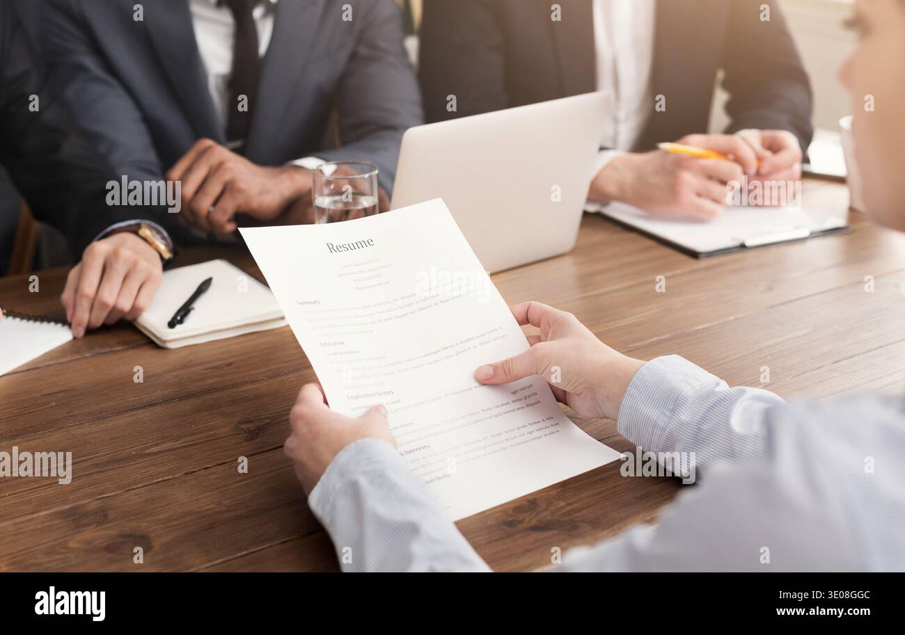 Female candidate holding resume during interview Stock Photo