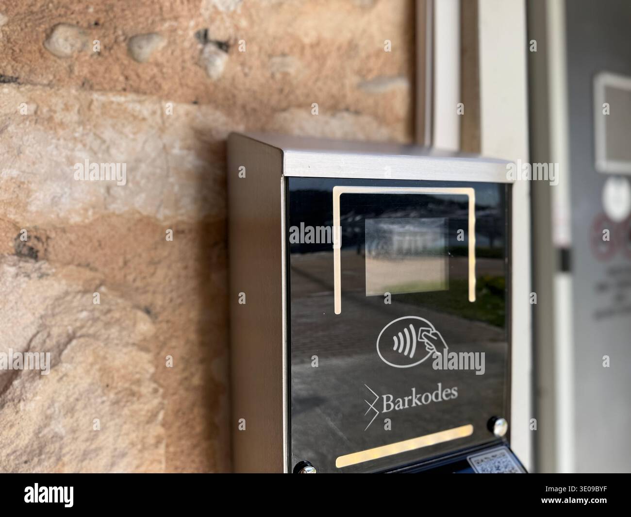 Electronic access control system with contactless reader installed on stone wall. Mobile photo Stock Photo