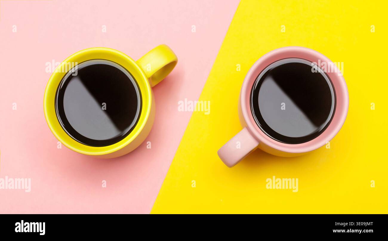 Flat lay top view of a two coffee cups with pink and yellow. Stock Photo