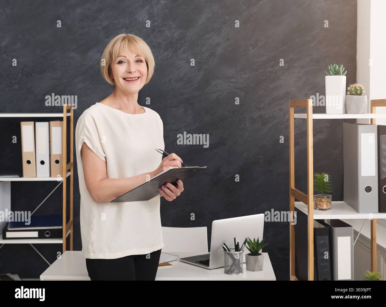 Confident businesswoman making notes in the office. Stock Photo
