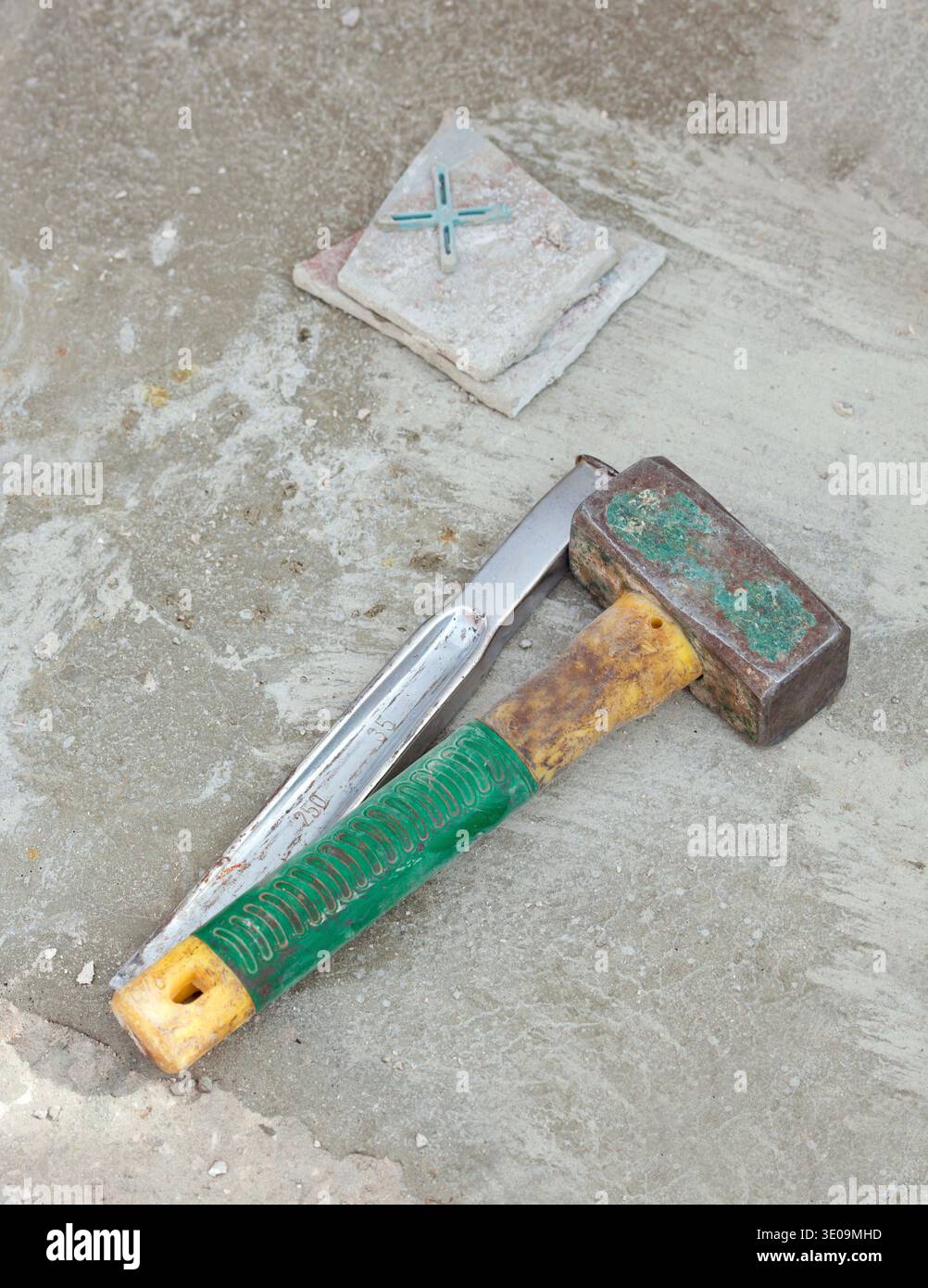 Awl and big hammer on concrete flooring Stock Photo