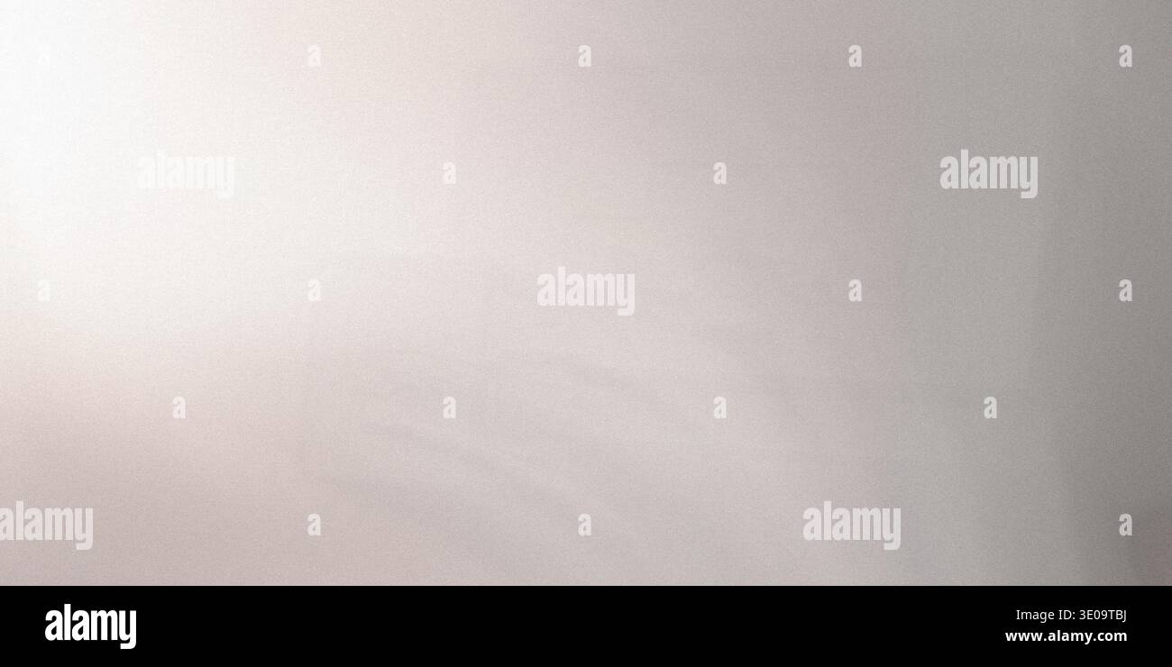 A gray background with a subtle gradient effect and a textured surface, transitioning from light to dark gray Stock Photo