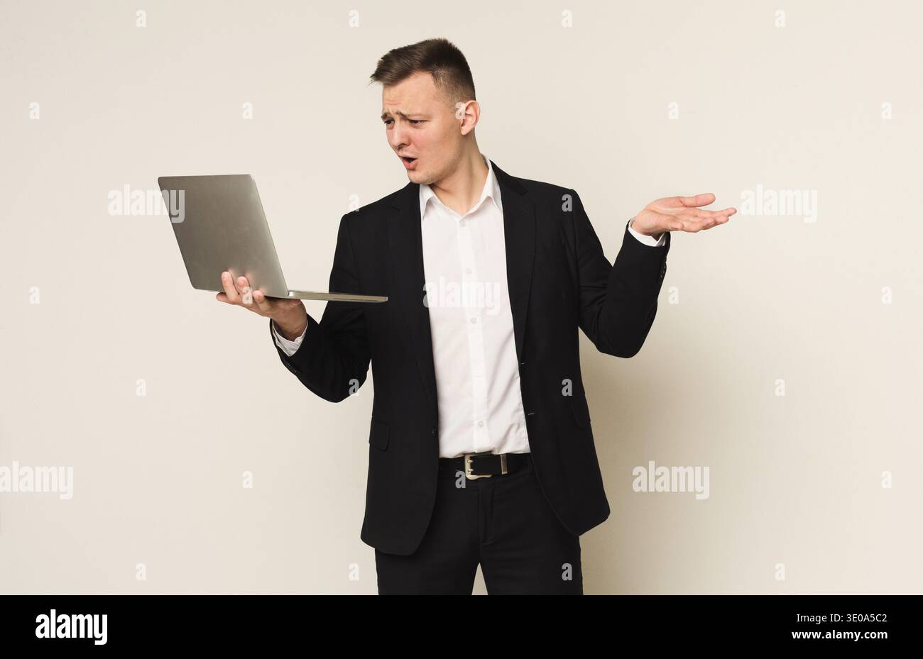 Disappointed caucasian businessman using laptop Stock Photo