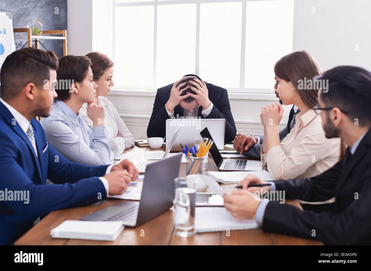Stressed boss having problem at business meeting Stock Photo