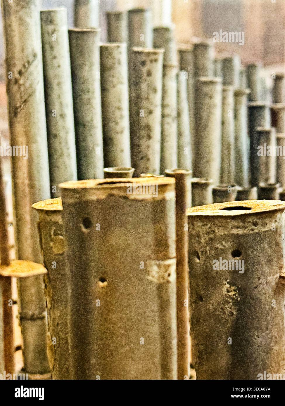 Old organ pipes, discolored and bent with age, are located in the cathedral of Salamanca. Stock Photo