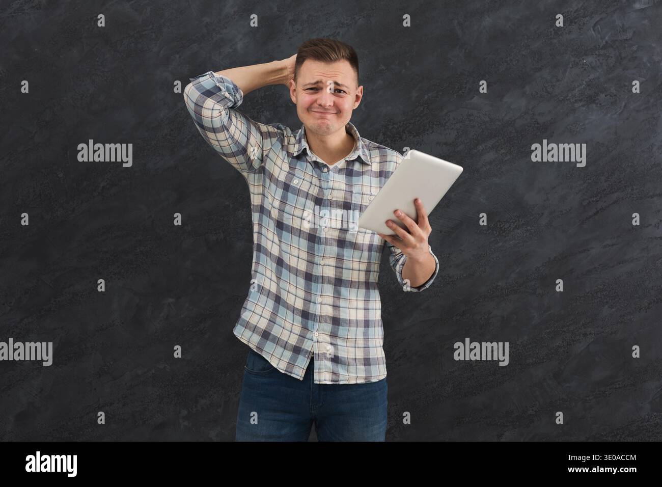 Disappointed caucasian man using tablet Stock Photo