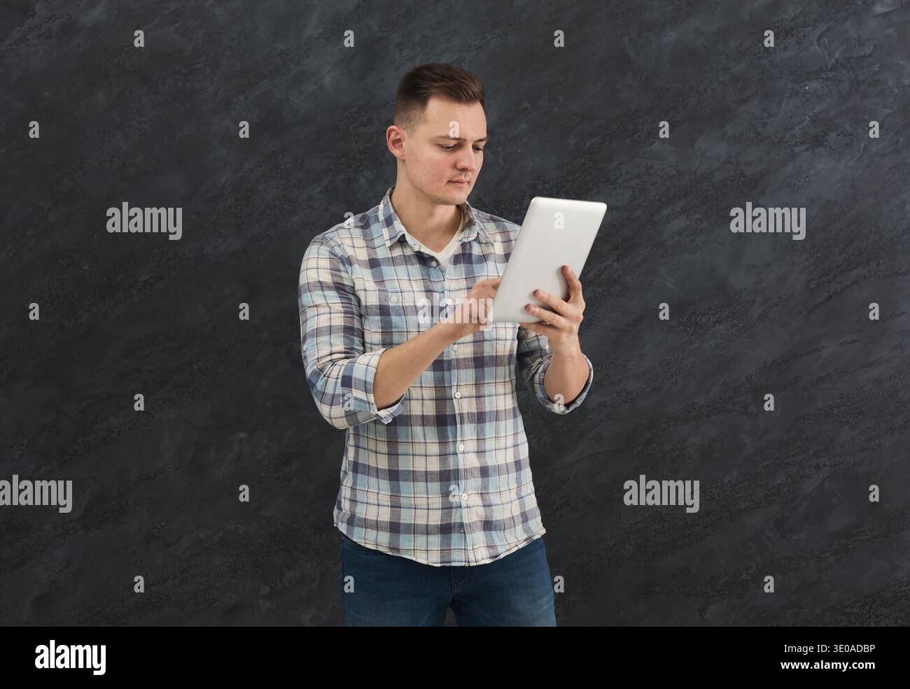 Young serious man using digital tablet Stock Photo