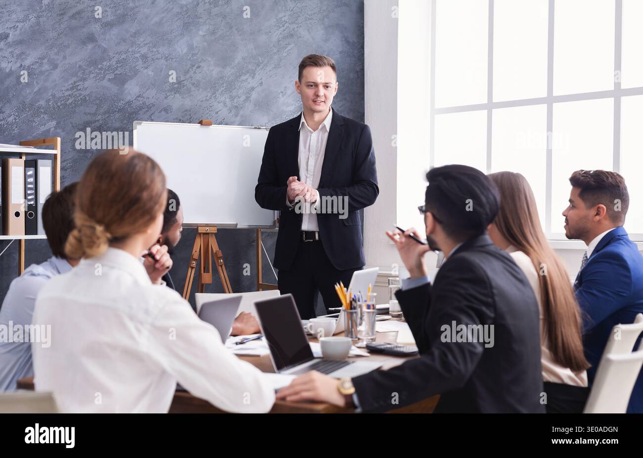 Young boss telling new hi-res stock photography and images - Alamy