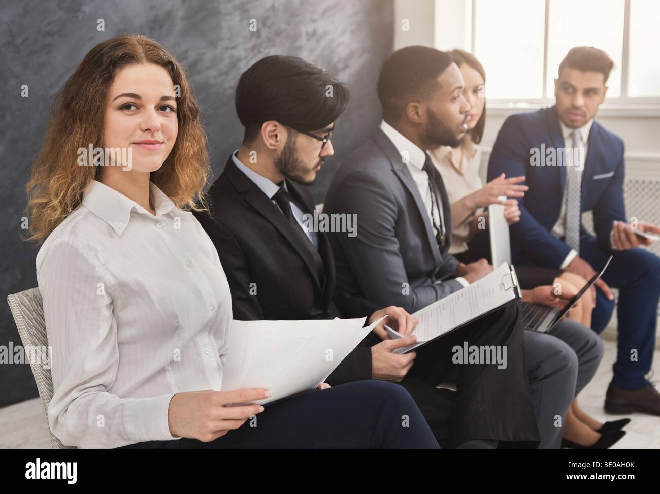 Multiracial people waiting in queue preparing for job interview Stock Photo