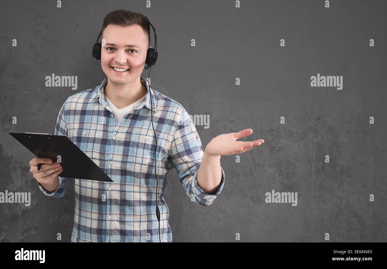 Young smiling man with headset, copy space Stock Photo